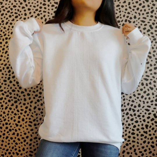 A woman holding a shirt for logo and branding.