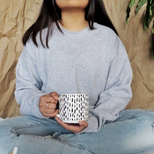 A woman holding a cup.