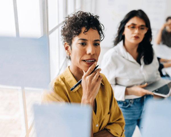 Two business women looking at their analytics.