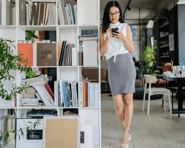 A marketers agency owner checking on her clients through her phone.