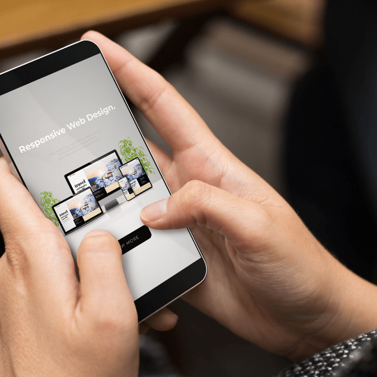 A person looking at a mobile website design in Miami.