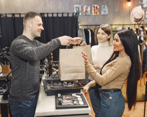 A happy customer receiving her bags.