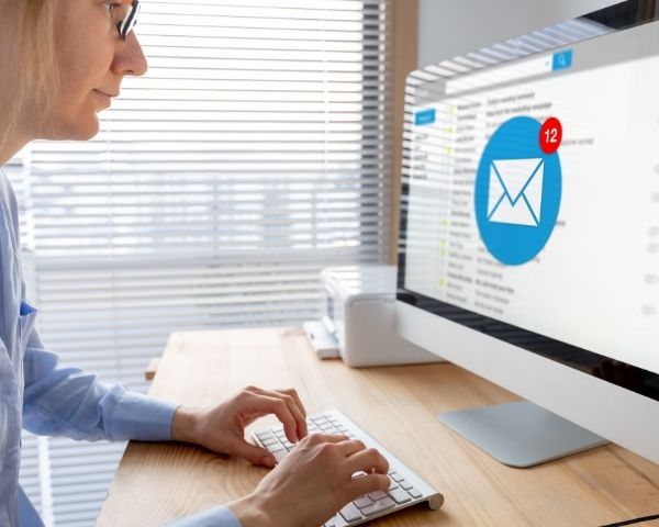 A woman at a marketing agency doing email marketing.