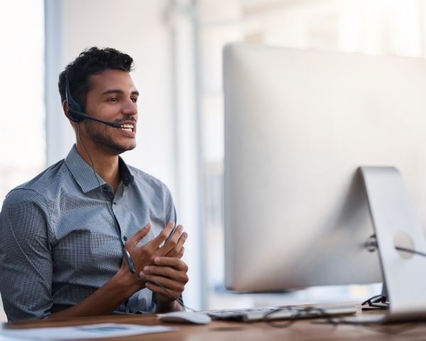 A man employed by an You Need to Understand SEO Agency USA talking into a zoom meeting camera.
