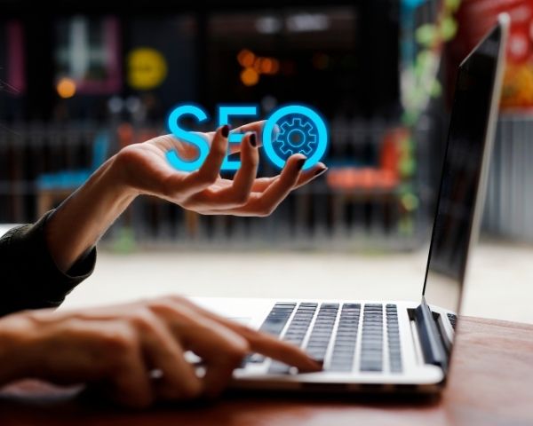A woman from an seo firms near me holding the wording seo.