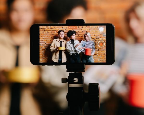 A video camera recording a group of friends.