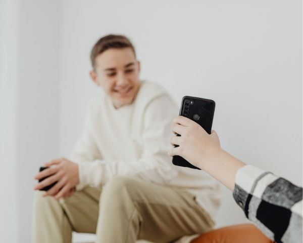 A person using the phone showing different web design firms.