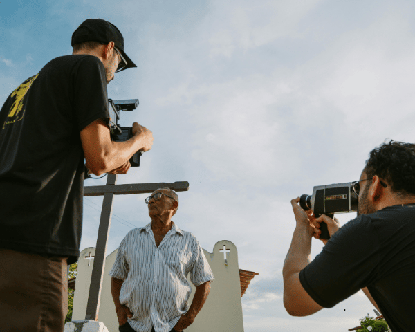 A crew from a social media company interviewing a man.