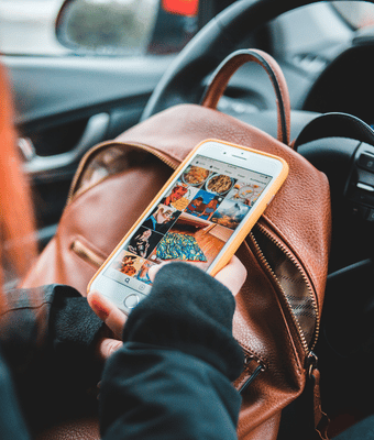 A woman on her phone looking at a good media strategy.