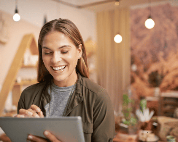 A women laughing at her phone interaction due to her social social ecommerce pursuit.